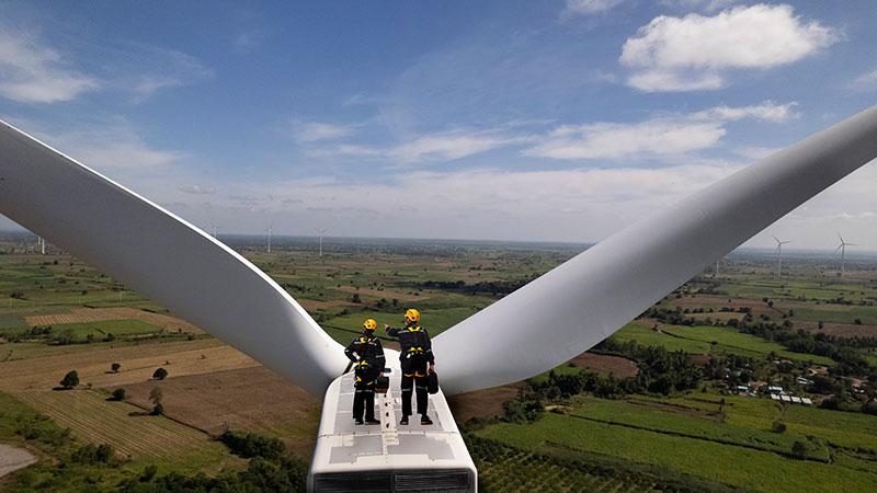 Maintenance workers on top of a windmill