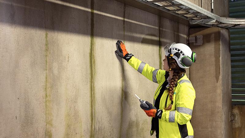 Person spot checking concrete wall with HM40